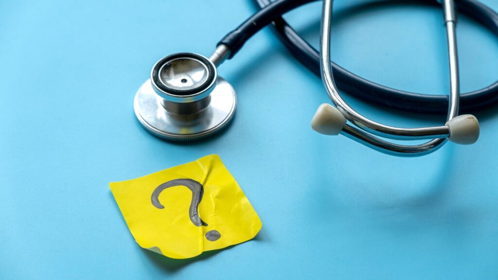 Stethoscope and sticky note with a question mark depicting medical questions to ask before starting regenerative medicine treatment