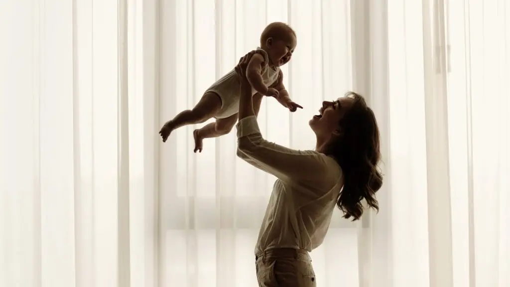 A mother playing with her baby happily after feeling absolute relief from PPD